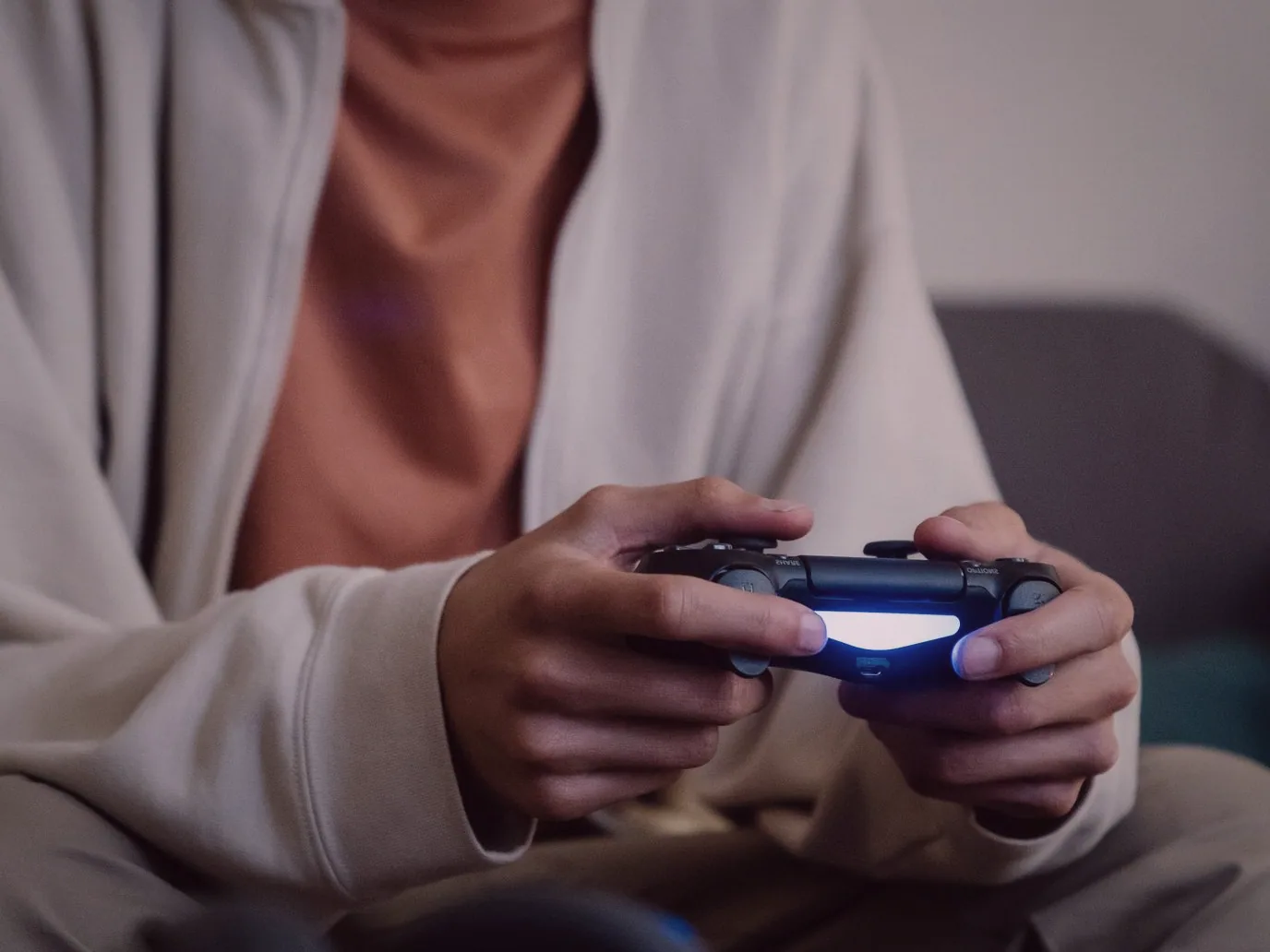 Adults sharing a couch and a controller during a cooperative game