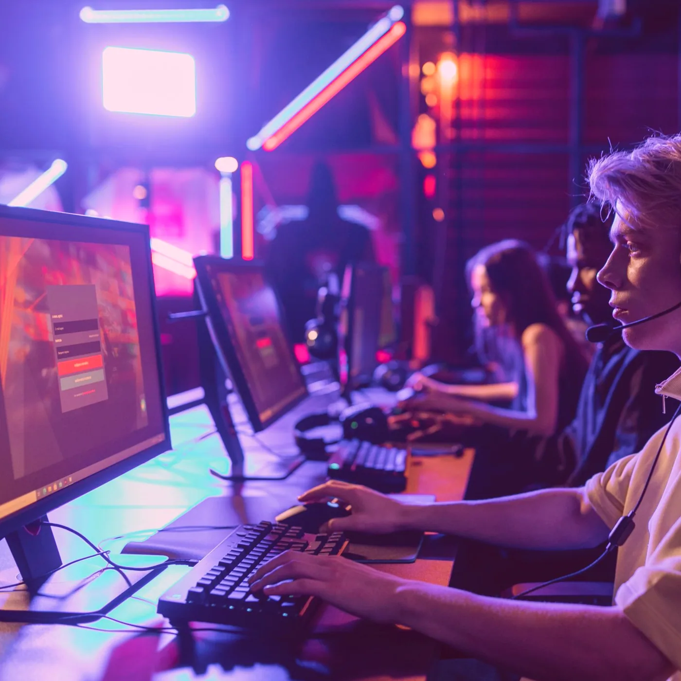A full room on league night with teams gathered around the screens